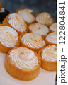 Creamy white tart with golden toasted top in shortcrust pastry on white plate in bakery display elegant dessert delicious sweet treat for food photography perfect pastry lovers indulgence 122804841
