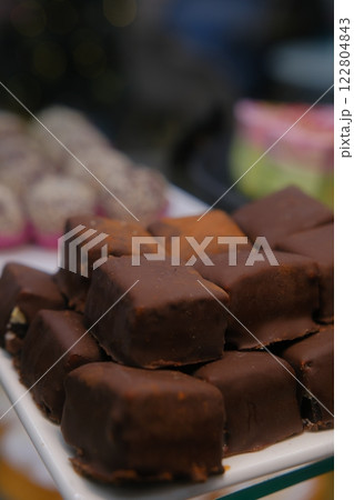 beautiful chocolate truffles on a white plate tempting handmade chocolates on display luxury confections rich chocolate treats delicious sweets gourmet indulgence mouthwatering chocolate 122804843