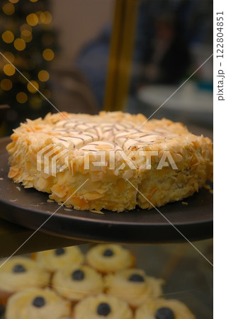 Beautiful black white hazelnut esterhazy cake topped almond slices on black plate on countertop elegant gourmet dessert rich layers flavor luxury pastry sweet indulgence sophisticated confection 122804851