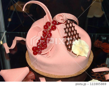 Elegant Pink Cake with Currants and Decorative Accents 122805869