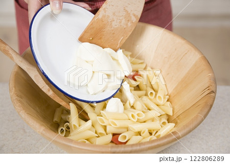 Adding Mozzarella to Pasta, Food Photography, Close View Background Adding Mozzarella to Pasta, Food Photography, Close View Background 122806289