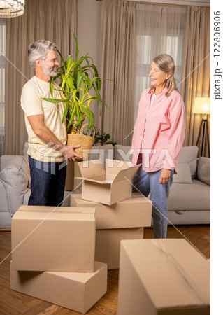 Senior family unpacking stuff in living room of their new apartment Senior family unpacking stuff in living room of their new apartment 122806906