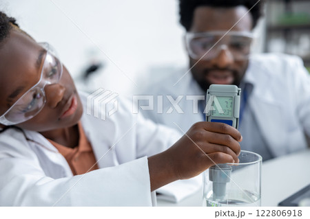 African american schoolgirl doing scientific experiments at the chemistry lesson 122806918