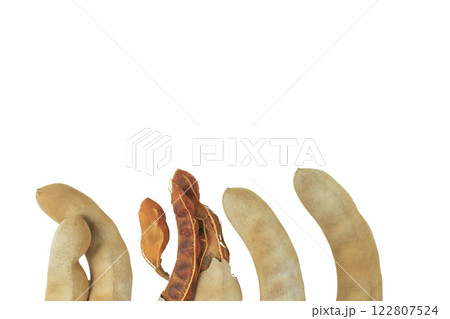 Cutout sour tamarind on white background. The variety with a sour taste comes from tartaric acid. Fresh pods are used in cooking to add sourness, mature pods are used to make tamarind paste. 122807524
