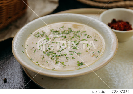 Creamy lentil soup with flatbread, sesame seeds, chili flakes, and lemon, served in an elegant style 122807826