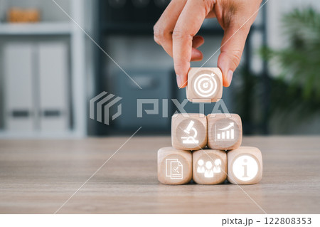 Wooden blocks with business icons representing market research, strategy, and analysis for planning and growth. 122808353