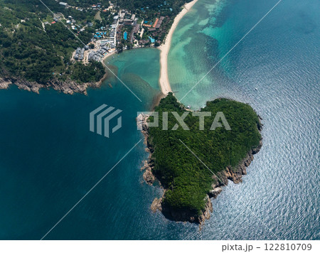 Top view of lush island next to a sandy beach and turquoise waters with sunlight reflection. Ko Pha Ngan, Thailand. 122810709