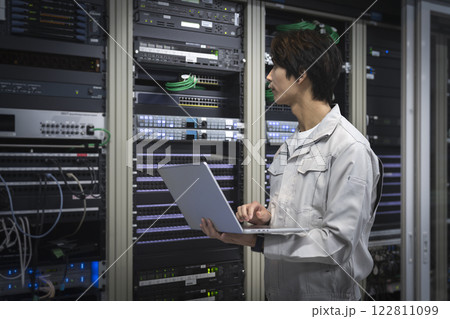 サーバーエンジニア イメージ ノートパソコンを持って作業をするエンジニア 横顔 サーバーエンジニア イメージ ノートパソコンを持って作業をするエンジニア 横顔 122811099