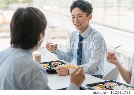 社員食堂でランチ・仕出し弁当・デリバリー・ケータリングの弁当を食べる男女（福利厚生） 122811751