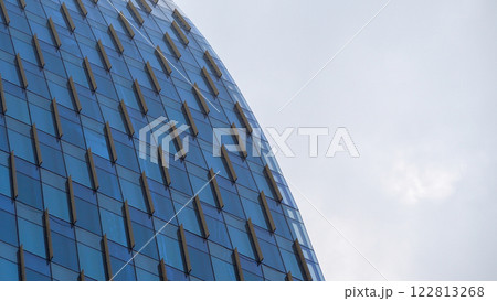 Curved Glass Facade - Modern skyscraper with repeating geometric patterns and a sleek curvature, perfect for showcasing architectural innovation, urban design concepts, or modern minimalism 122813268