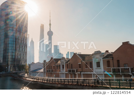 woman traveler visiting in Shanghai, China. Female Tourist with backpack sightseeing Shanghai view of Lujiazui in Hongkou Gang canal of Shanghai. landmark and popular for tourism attraction woman traveler visiting in Shanghai, China. Female Tourist with backpack sightseeing Shanghai view of Lujiazui in Hongkou Gang canal of Shanghai. landmark and popular for tourism attraction 122814554