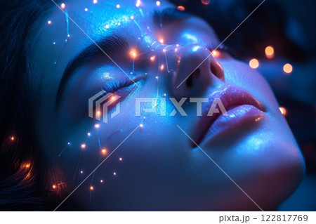 Young woman's face is lit up with bright lights, creating dreamy and ethereal atmosphere 122817769