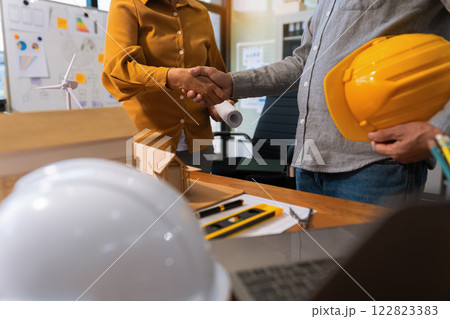 architects and engineers shake hands while working for teamwork. 122823383