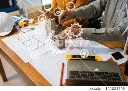 Architect team working with blueprints for sketching a construction project. Architect team working with blueprints for sketching a construction project. 122823396