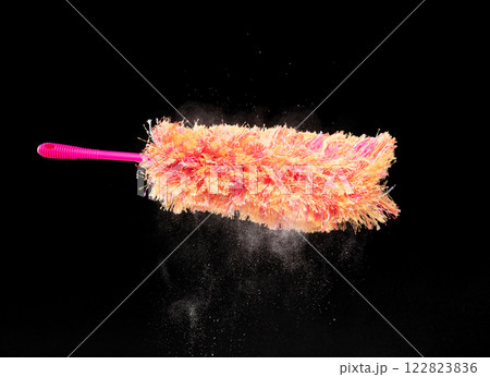 Orange microfiber Duster stick made from synthetic to clean house dust and web. Room Ceiling and window covered with dust bunnies, cobweb cleaned by microfiber duster stick. Black background isolated Orange microfiber Duster stick made from synthetic to clean house dust and web. Room Ceiling and window covered with dust bunnies, cobweb cleaned by microfiber duster stick. Black background isolated 122823836