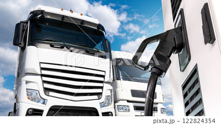 Electric vehicles charging station on a background of a trucks 122824354