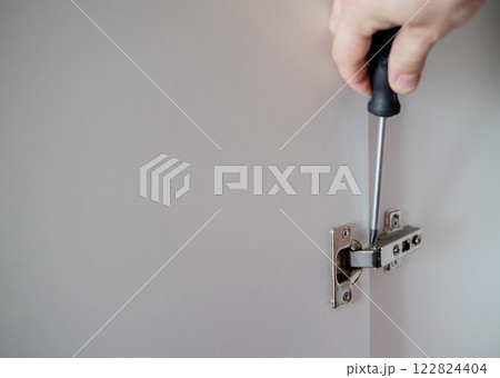 A man hands with screwdriver A man hands with screwdriver 122824404