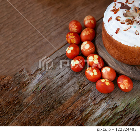 Easter food background. Red dyed eggs with onion peel and clover and dill leaves. Easter cake on a wooden table. Spring homemade DIY craft. Easter food background. Red dyed eggs with onion peel and clover and dill leaves. Easter cake on a wooden table. Spring homemade DIY craft. 122824485