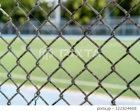 Rusty fence surrounding sports field outdoor area urban environment close-up texture detail 122824608
