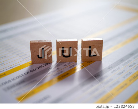 July calendar preparation office setting document close-up organized workspace planning concept July calendar preparation office setting document close-up organized workspace planning concept 122824655