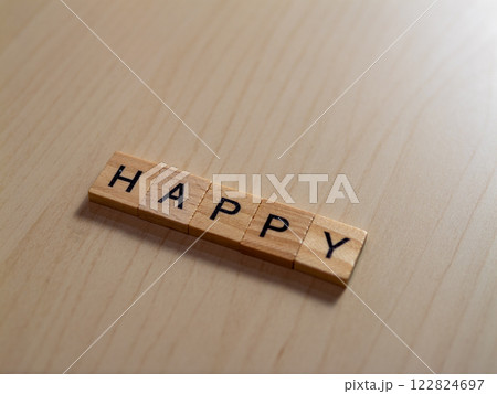 Celebrating joy happy letters a wooden table indoor setting close-up view positive vibes Celebrating joy happy letters a wooden table indoor setting close-up view positive vibes 122824697