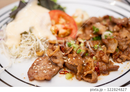 Sizzling grilled meat dish restaurant kitchen food warm atmosphere close-up culinary delight 122824827