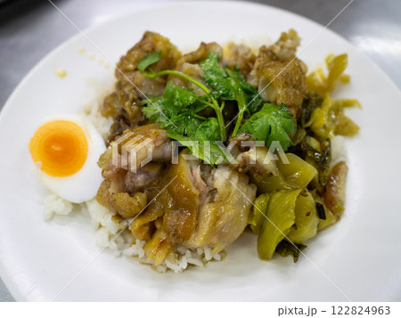 Delicious chicken rice dish with egg local eatery food urban setting close-up culinary delight Delicious chicken rice dish with egg local eatery food urban setting close-up culinary delight 122824963