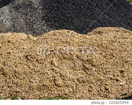 Construction material piles industrial site outdoor close-up raw materials Construction material piles industrial site outdoor close-up raw materials 122825054