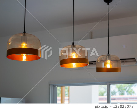 Stylish pendant lighting installation modern home interior design bright atmosphere aesthetic appeal 122825078