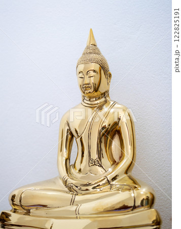 Golden buddha sculpture serene artistry spiritual space home decor warm atmosphere close-up view Golden buddha sculpture serene artistry spiritual space home decor warm atmosphere close-up view 122825191