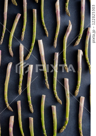 Green asparagus pattern on background. Vegetable sprouts stems Green asparagus pattern on background. Vegetable sprouts stems 122825303