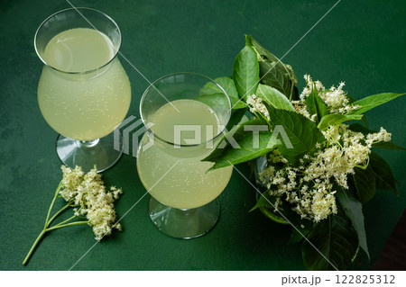 Carbonated elderflower drink. Flower summer kvass in glasses Carbonated elderflower drink. Flower summer kvass in glasses 122825312