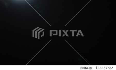 Real optic lens flare over black background for overlay or background 122825782