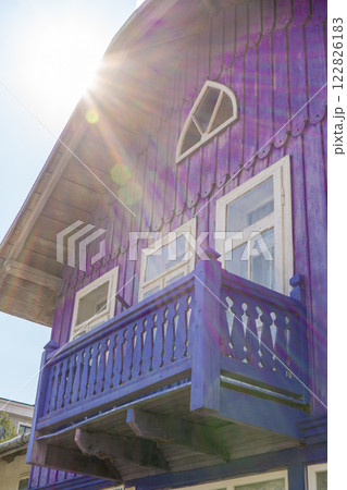 Wooden balcony of a wood house. Exterior facade. Blue color 122826183