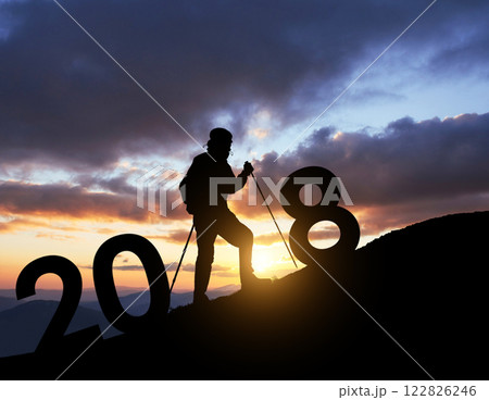 Silhouette young hiker man for 2018 new year background of the sunset Silhouette young hiker man for 2018 new year background of the sunset 122826246
