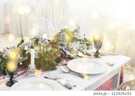 Table served for Christmas dinner in living room, close up view. Bokeh light soft effect Table served for Christmas dinner in living room, close up view. Bokeh light soft effect 122826281