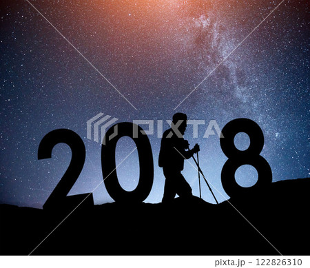 Silhouette young hiker man for 2018 new year background of the Milky Way galaxy on a bright star dark sky tone Silhouette young hiker man for 2018 new year background of the Milky Way galaxy on a bright star dark sky tone 122826310