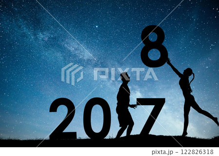 Silhouette young girl and guy. Happy 2018 new year. Background of the Milky Way galaxy on a bright star dark sky tone. Concept change year 2017 to 2018 Silhouette young girl and guy. Happy 2018 new year. Background of the Milky Way galaxy on a bright star dark sky tone. Concept change year 2017 to 2018 122826318