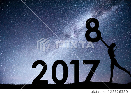 Silhouette young girl. Happy 2018 new year. Background of the Milky Way galaxy on a bright star dark sky tone. Concept change year 2017 to 2018 Silhouette young girl. Happy 2018 new year. Background of the Milky Way galaxy on a bright star dark sky tone. Concept change year 2017 to 2018 122826320