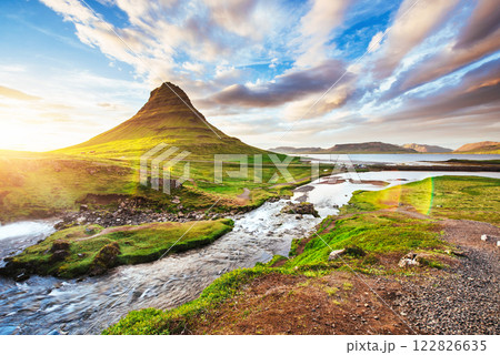 The picturesque sunset over landscapes and waterfalls. Kirkjufell mountain, Iceland The picturesque sunset over landscapes and waterfalls. Kirkjufell mountain, Iceland 122826635