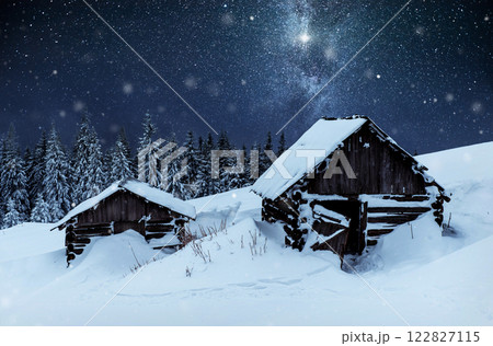 Night with stars. Christmas landscape. Wooden house in the mountain village. Night landscape in winter Night with stars. Christmas landscape. Wooden house in the mountain village. Night landscape in winter 122827115