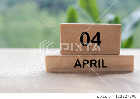 4 April calendar on wooden table with customizable space for text, ideas or messages. Calendar and copy space concept 122827309