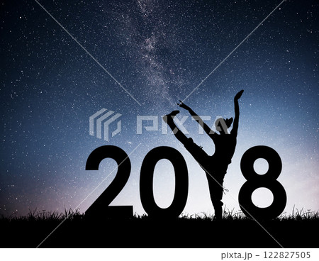 Silhouette of a young girl doing fitness. 2018 new year background of the Milky Way galaxy on a bright star dark sky tone Silhouette of a young girl doing fitness. 2018 new year background of the Milky Way galaxy on a bright star dark sky tone 122827505