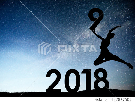 Silhouette young girl. Happy 2019 new year. Background of the Milky Way galaxy on a bright star dark sky tone. Concept change year 2018 to 2019 122827509