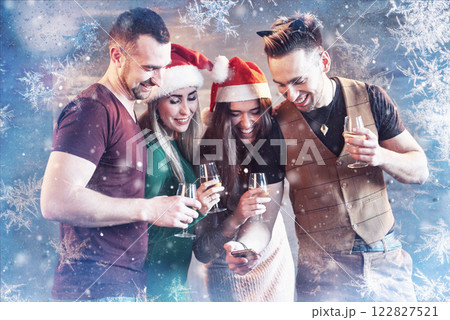 Cheerful old friends communicate with each other and phone watch, with glasses of champagne in new year party. Concept of entertainment and lifestyle. Wifi connected people 122827521