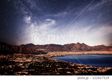 old town by the sea, low mountains in the background, dramatic star sky. old town by the sea, low mountains in the background, dramatic star sky. 122827529