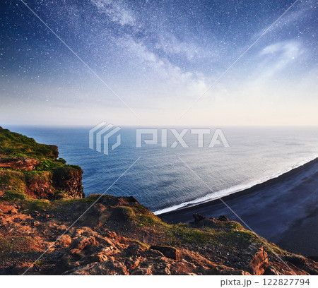 The black sand beach and mountains Reynisfjara from Cape at sunset in Iceland The black sand beach and mountains Reynisfjara from Cape at sunset in Iceland 122827794