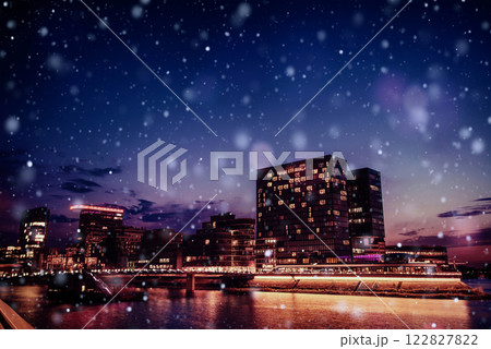 Panorama of the night city of Dusseldorf in winter during a snowstorm. Bokeh light effect, soft filter 122827822