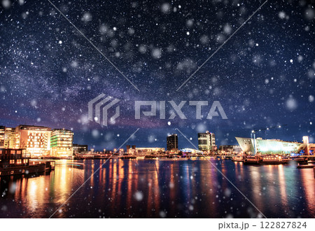 Beautiful night in Amsterdam. Night illumination of buildings and boats near the water in the canal during a snowstorm. Bokeh light effect, soft filter Beautiful night in Amsterdam. Night illumination of buildings and boats near the water in the canal during a snowstorm. Bokeh light effect, soft filter 122827824