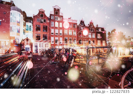 Beautiful calm night view of Amsterdam city during a snowstorm. Bokeh light effect, soft filter 122827835